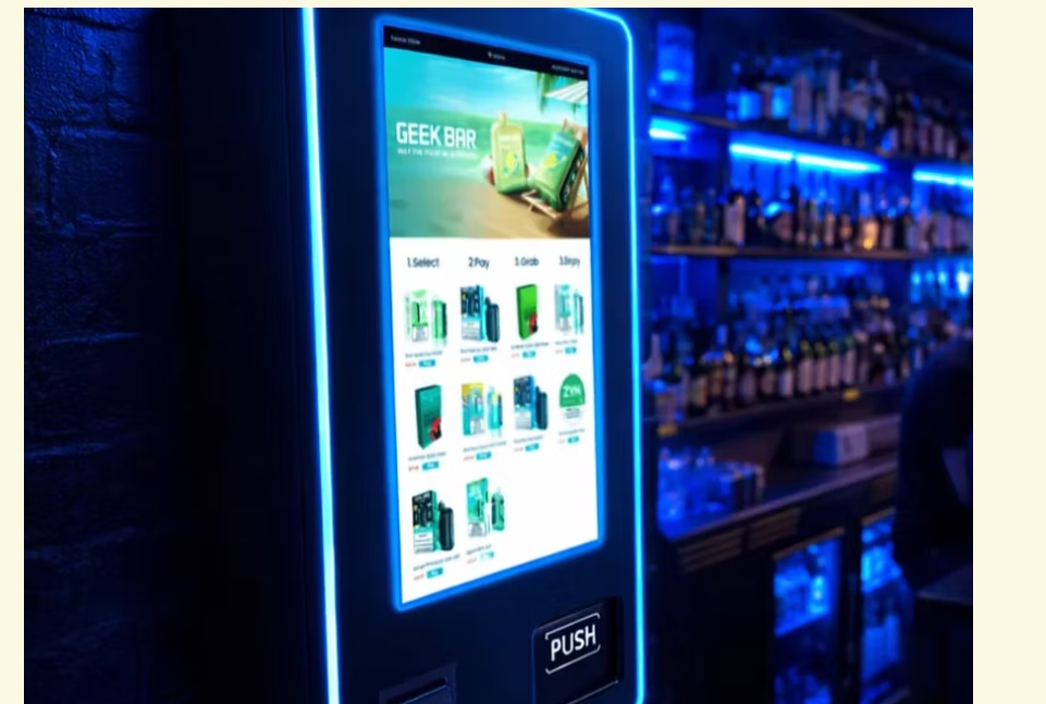 GEEK BAR vape vending machine lit in blue neon at a bar
